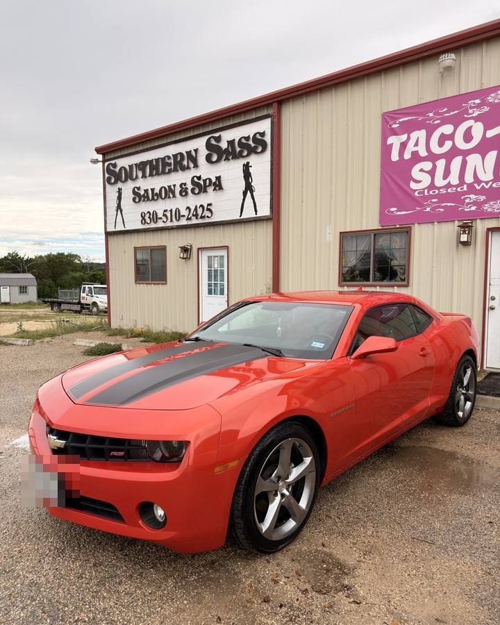 Red Camaro being washed after
