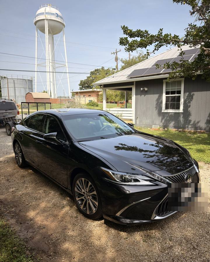 Black Lexus sedan being washed after