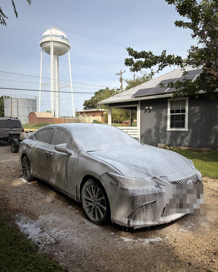 Black Lexus sedan being washed before